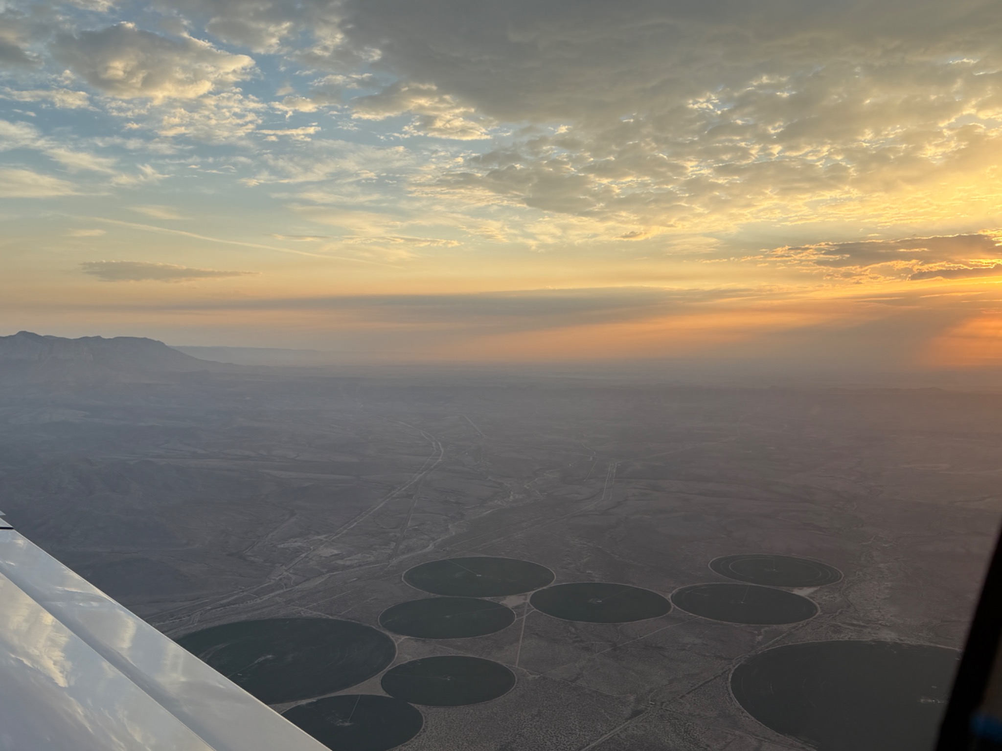 Warm evening light over the desert landscape from an aircraft